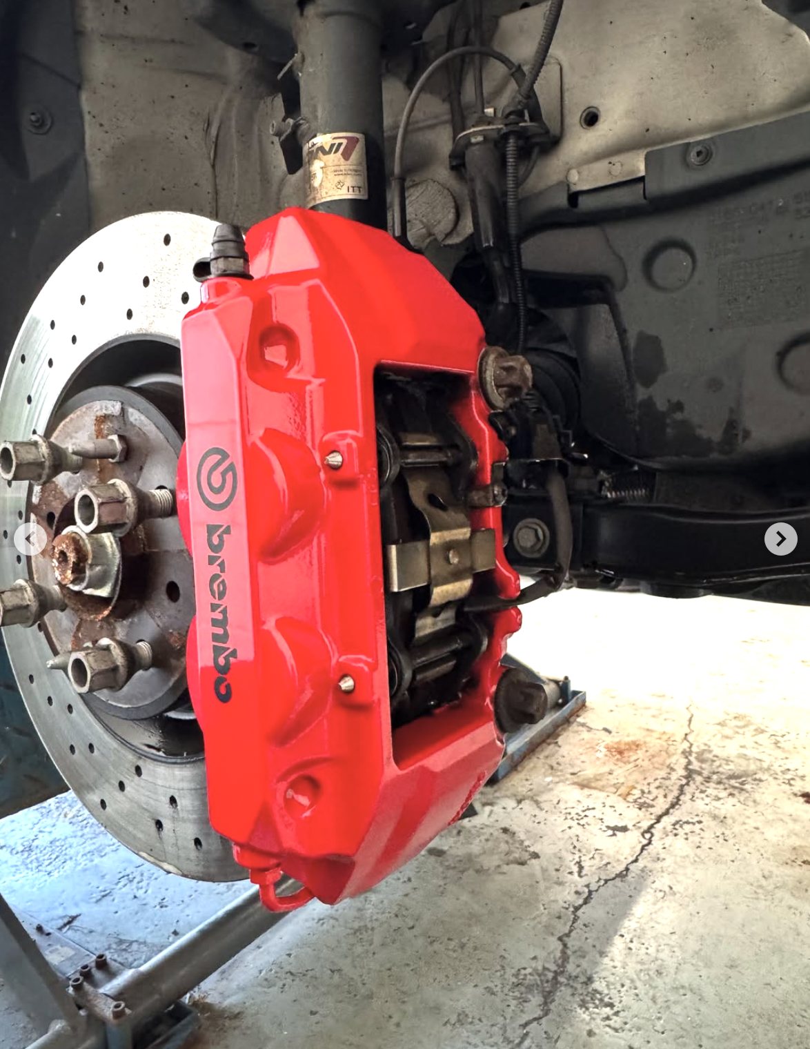 Brembo brake caliper after restoration — fresh gloss-red finish