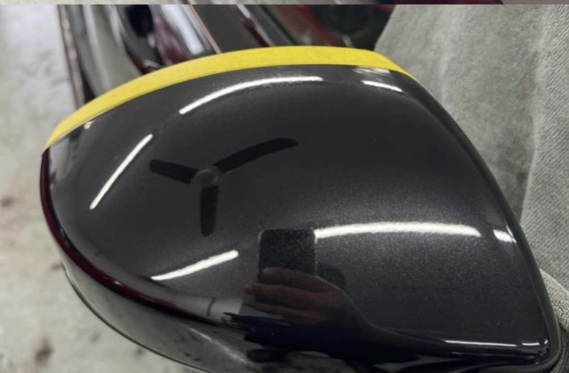 Black wing mirror after paint correction — deep gloss restored